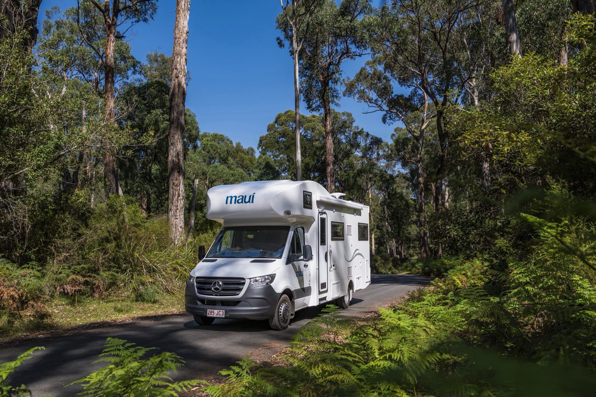 Motorhome driving through an Australian forest